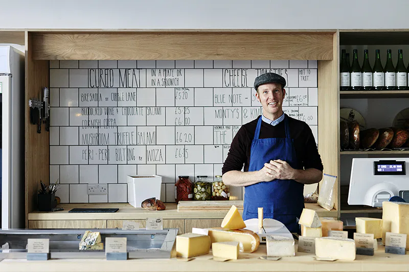 Une fromagerie avec un vendeur de fromage
