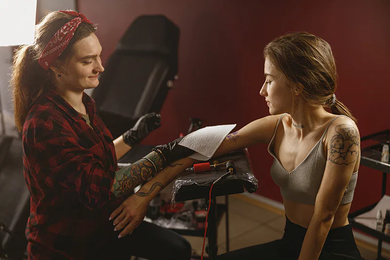 Un salon de tatouage et piercing avec une personne qui se fait tatouer